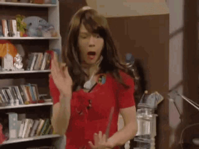 a man in a red shirt is wearing a wig