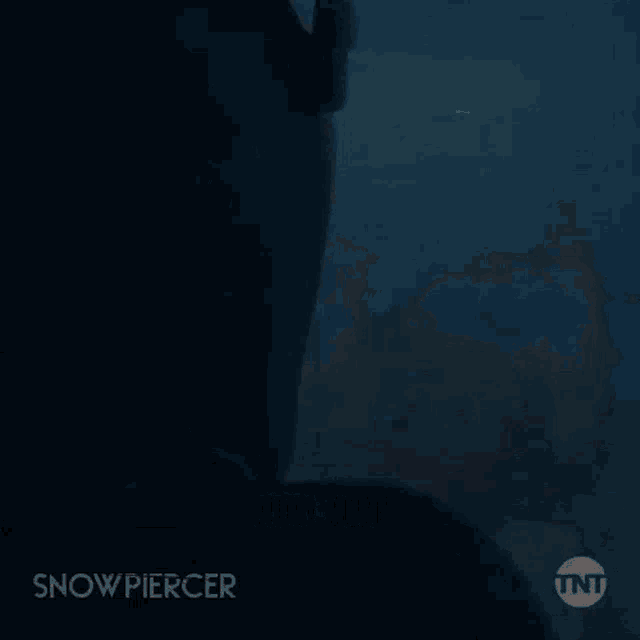 a dark room with a chandelier hanging from the ceiling and a sign that says snow piercer