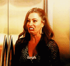 a woman is making a funny face in front of a refrigerator door .
