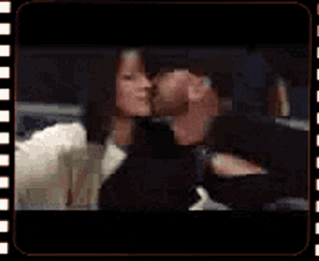 a man is kissing a woman on the cheek in a film strip