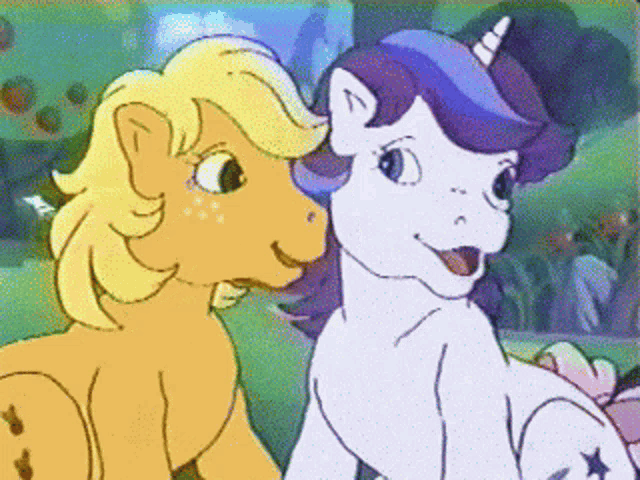 two ponies are standing next to each other and one has a horn