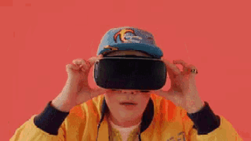 a person wearing a virtual reality headset with a question mark on the screen .