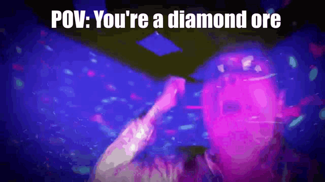 a man is dancing in a room with purple lights and the words pov : you 're a diamond ore on the bottom