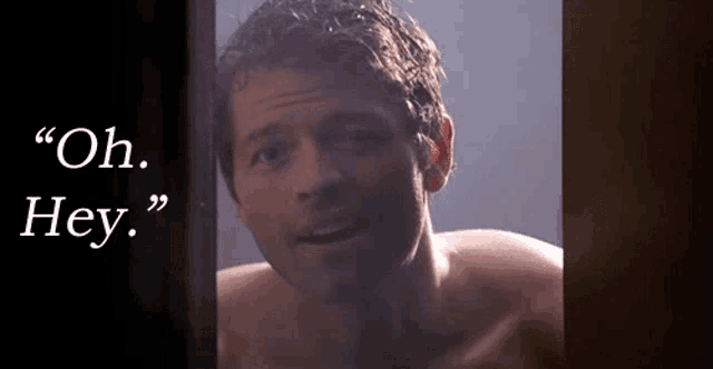 a shirtless man is standing in front of a sign that says oh hey