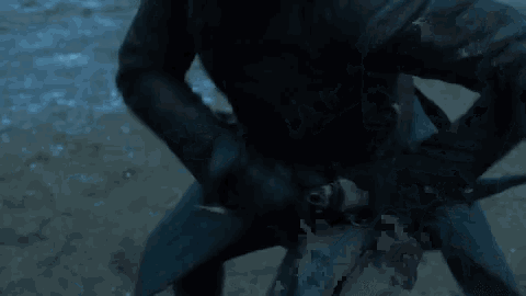 a person holding a large knife in their hand in the snow