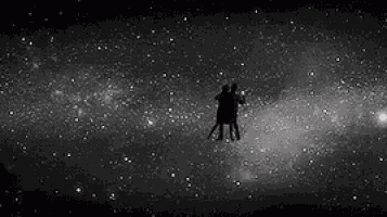 a man and a woman are holding hands in front of a clock .