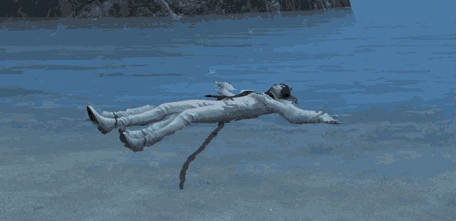 a person is laying in the water with their arms outstretched
