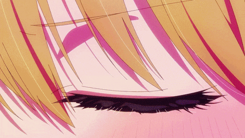 a close up of a woman 's eye with a pink background