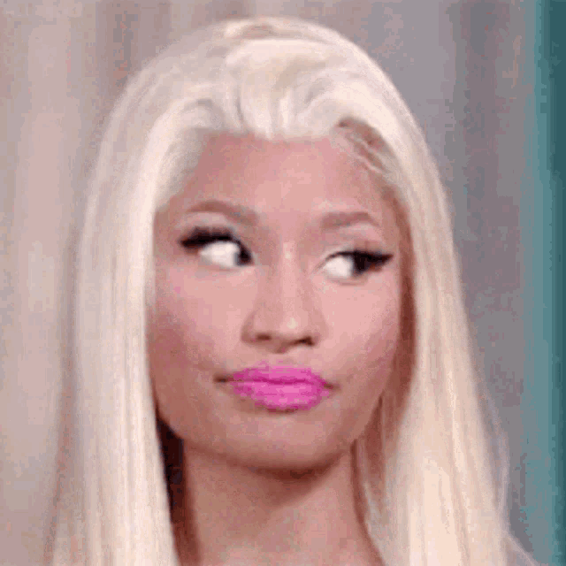 a close up of a woman 's face with blonde hair and pink lipstick .