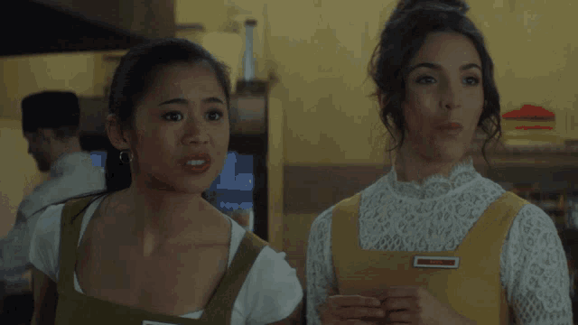 two women are standing next to each other and one of them has a name tag that says red ribbon