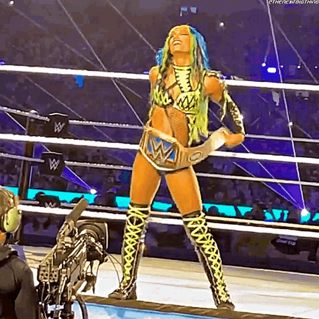 a woman with green hair is standing in a wrestling ring holding a trophy
