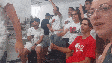 a group of people wearing shirts that say ljubav are sitting in a room