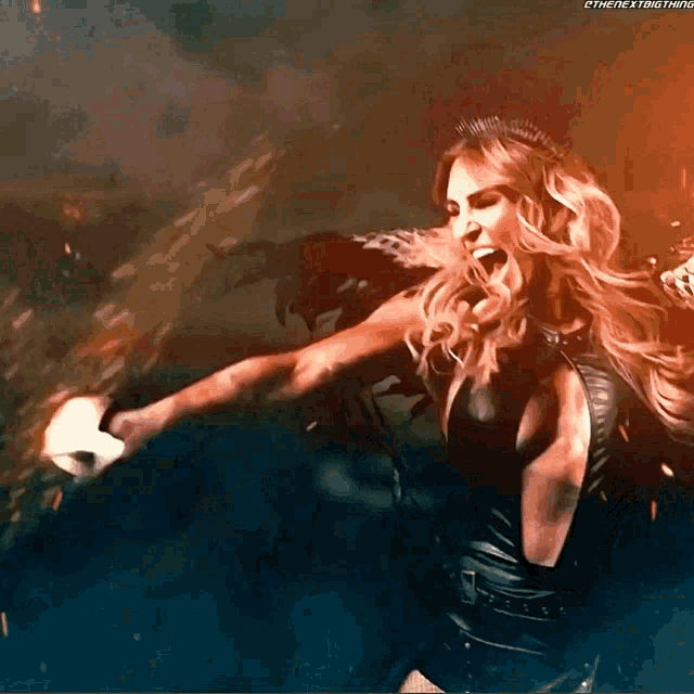 a woman with a crown on her head throws a punch with the hashtag #thenextthing