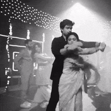 a black and white photo of a couple dancing