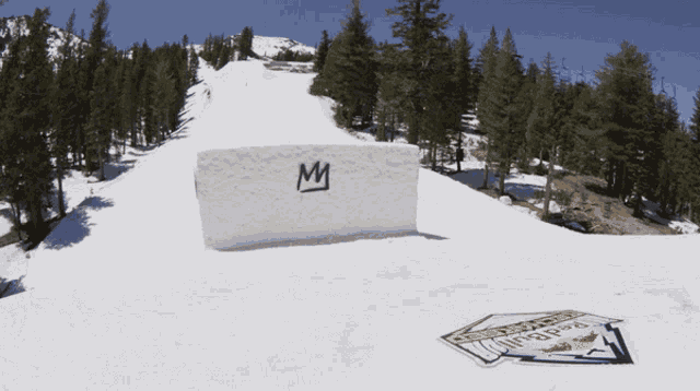 a snowy slope with a sign that says ' redbull ' on it