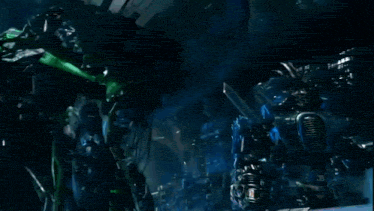 two robots are standing next to each other in a dark room ..