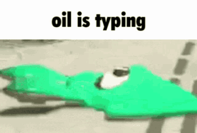 a green toy is laying on the ground with the words `` oil is typing '' written above it .