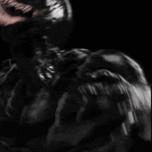 a close up of a person with venom coming out of their mouth .