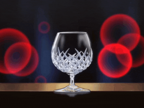 a bottle is being poured into a wine glass