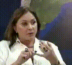 a woman in a white shirt is holding a pair of scissors
