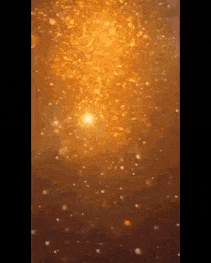 a close up of a candle with a lot of sparkles on it