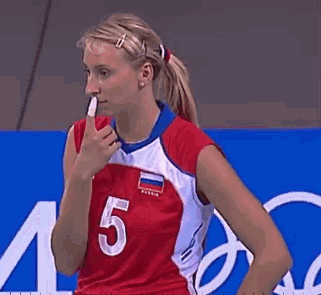 a female volleyball player with the number 5 on her shirt
