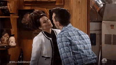 a man and woman are standing next to each other in a kitchen .