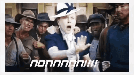 a woman in a white hat stands in front of a group of men and says nonnnon