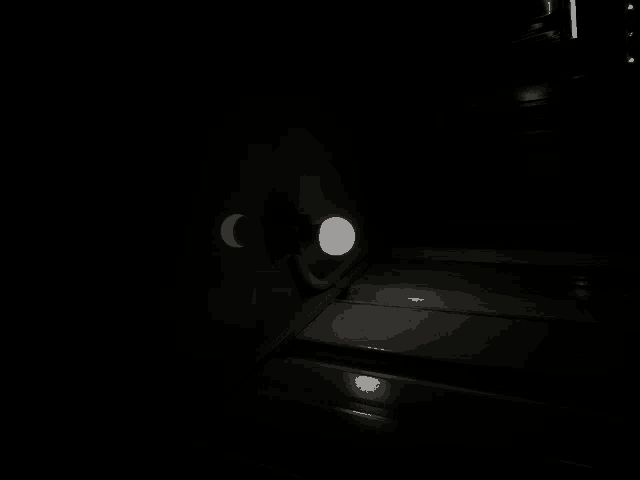 a light is shining in the dark and a crescent moon is visible