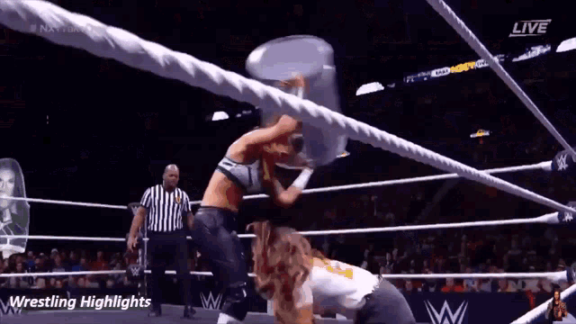 two women are wrestling in a wrestling ring with a referee and the words wrestling highlights on the bottom