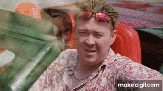 a man wearing sunglasses is sitting in a convertible car