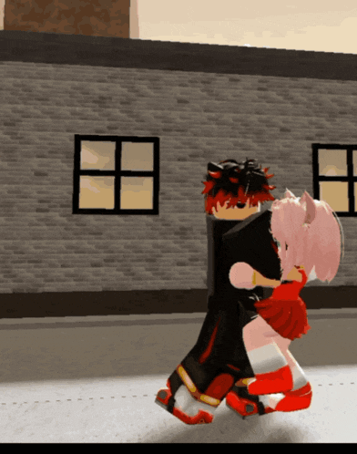 a boy and a girl dancing in front of a brick wall