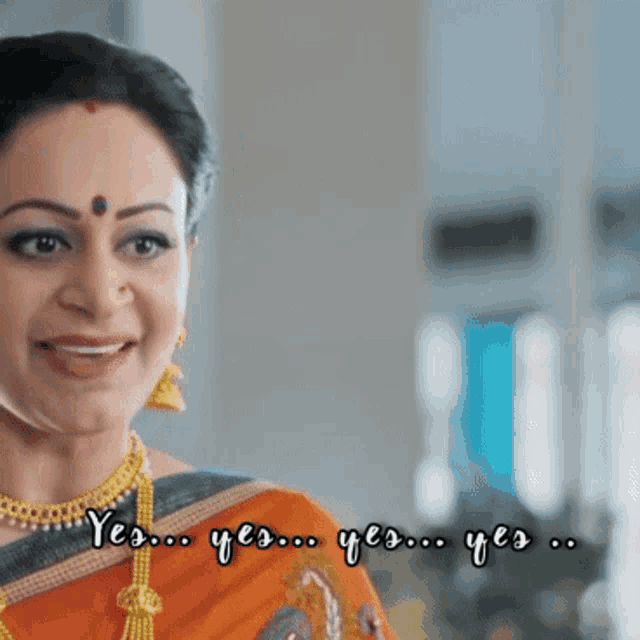 a woman in an orange saree is smiling with the words yes yes yes yes yes written below her