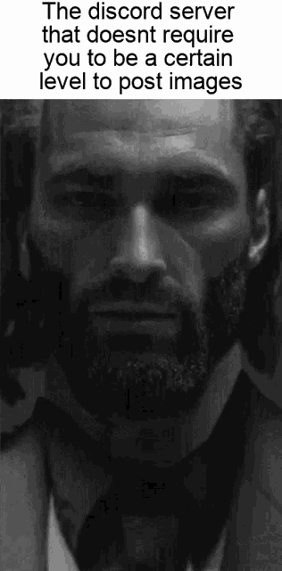 a black and white photo of a man with a beard in a suit and tie