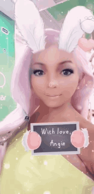 a woman wearing bunny ears has a sign that says with love angie
