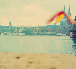 a butterfly with red and yellow wings is sitting on a beach