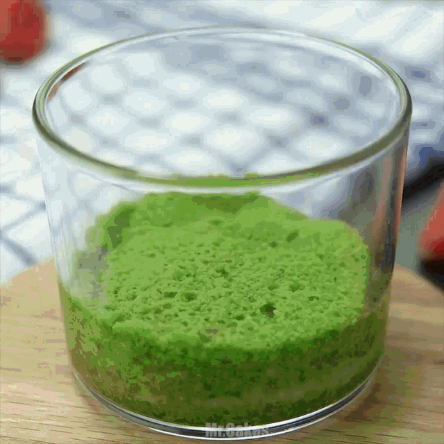 a glass filled with a green substance that says mr. smith on it