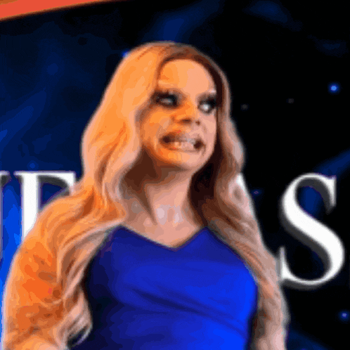 a woman in a blue dress is standing in front of a sign that says ' jesus '