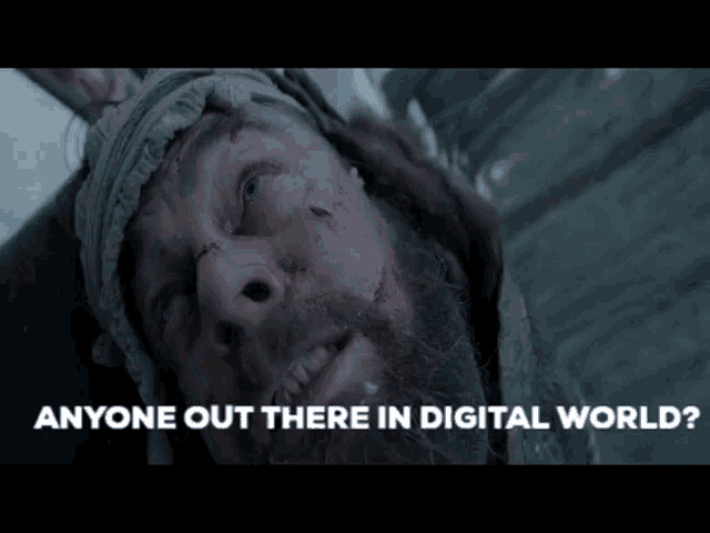 a man with a beard is laying in the snow with the words " anyone out there in digital world " above him