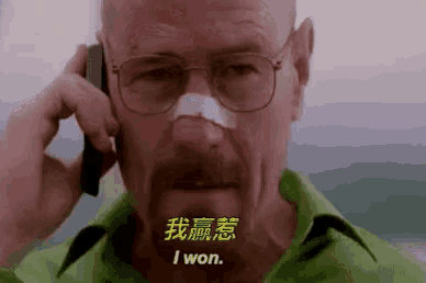 a man with glasses and a bandage on his nose is talking on a cell phone