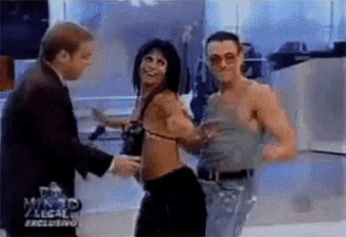 a man in a suit and a woman in a bikini are dancing in front of a sign that says mundo legal