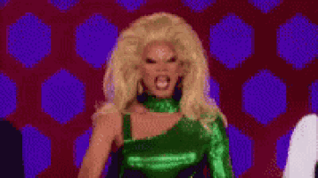 a pixelated image of a drag queen in a green dress giving a high five .