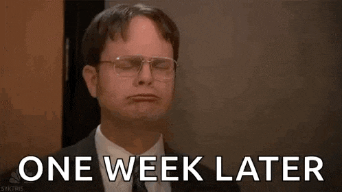 a man in a suit and tie is sitting in a chair with his eyes closed and the words `` one week later '' .