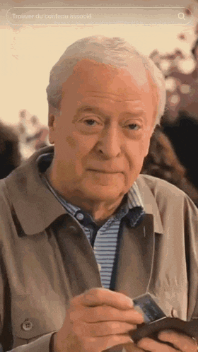 an elderly man is holding a credit card and a wallet