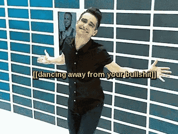 a man with his arms outstretched is dancing away from a wall