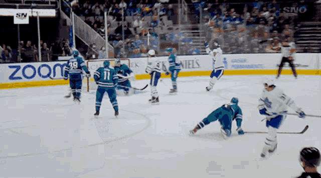 a hockey game is being played in front of a banner that says zoom on it