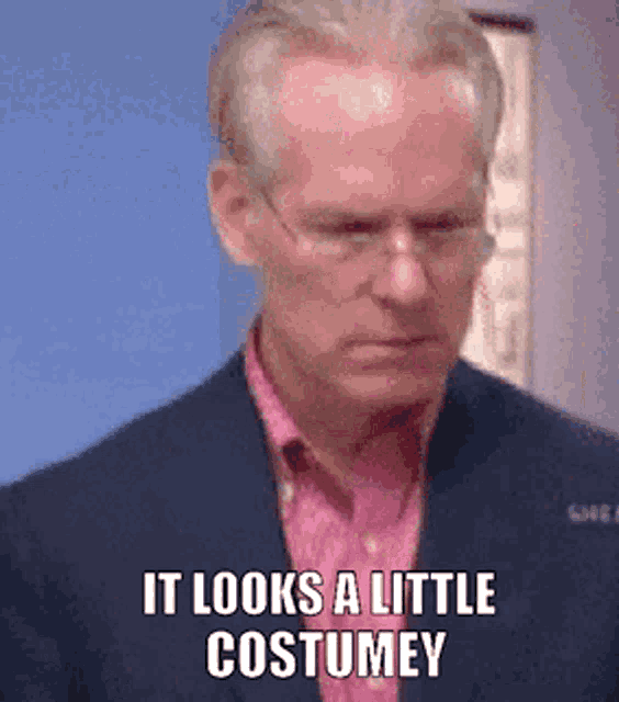 a man in a suit and pink shirt says `` it looks a little costume '' .