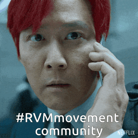a man with red hair talking on a cell phone with #rvm movement community written below him