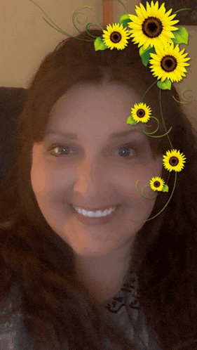 a smiling woman with sunflowers on her head