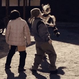 a man and a woman are standing next to each other looking at a horse